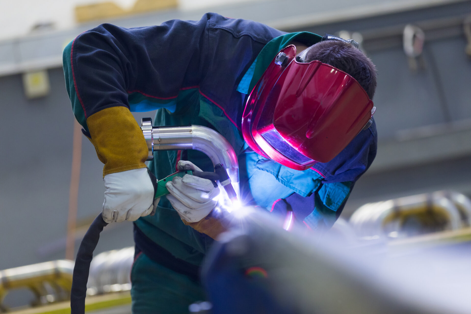Industrial worker welding in metal factory. what can i earn as a welder